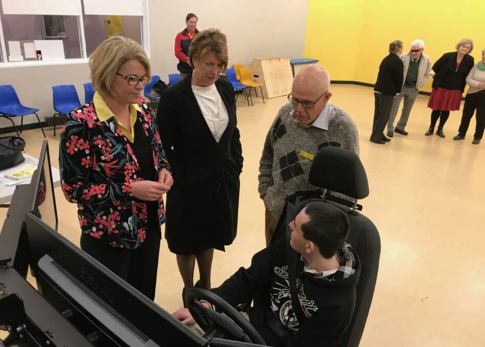 Member for Cootamundra Katrina Hodgkinson and NSW Minister for Roads Melinda Pavey with Young's Rotary Youth Director Frank Lincoln and Young's Adam Peddie, 20, at the Rotary driving simulator in Young this week.