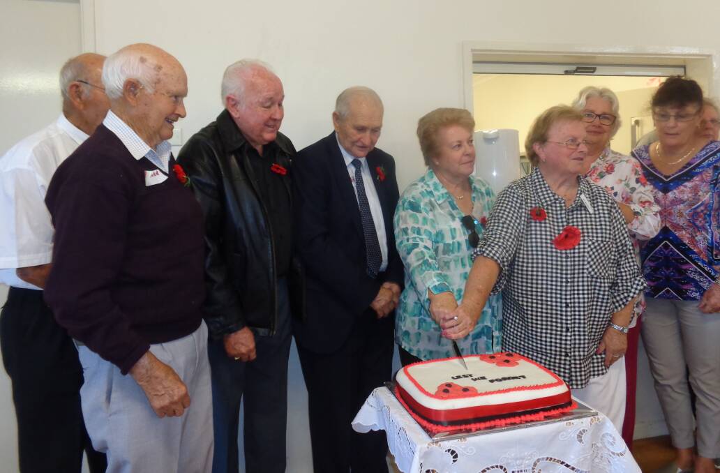 Bill Rudd with close family members cutting the Rudd/Clarke memorial reunion cake. (contributed) 
