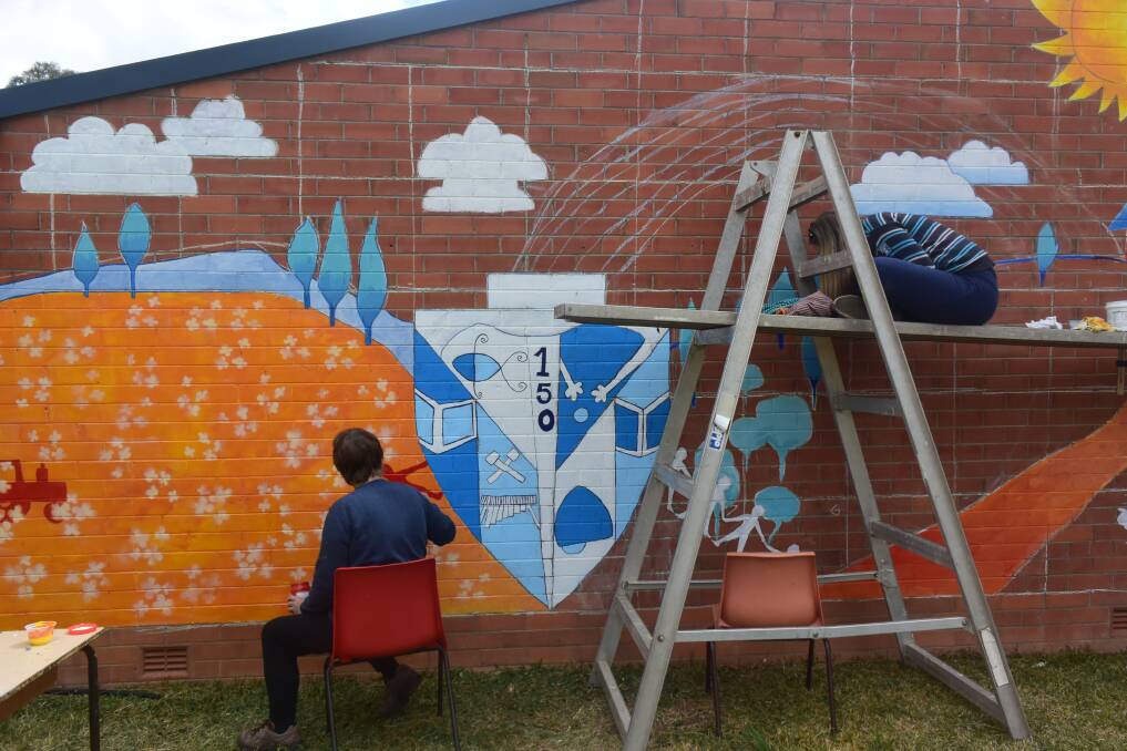 Mural designer and GPS teacher Francesca Nolan is busy completing the masterpiece with the help of her mum Kerry Suttonberg. 