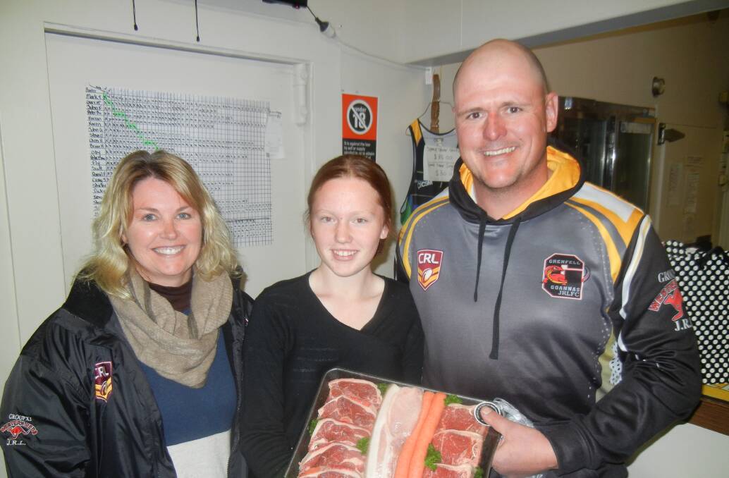 Taylor King winner of the meat draw at Junior League's  home game BBQ with Isabelle Homes and Matt Reid. 