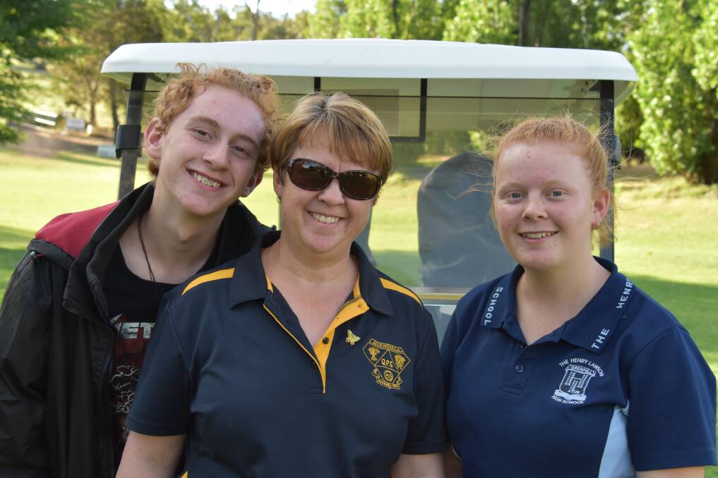 Kate Johnson (M) with son Jack (L) and daughter Jade helping mum celebrate her birthday with a game of golf.