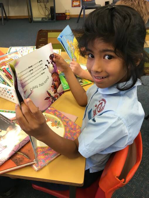 READING: Nilara enjoying time to read in class. Photo St Joseph's Primary School.