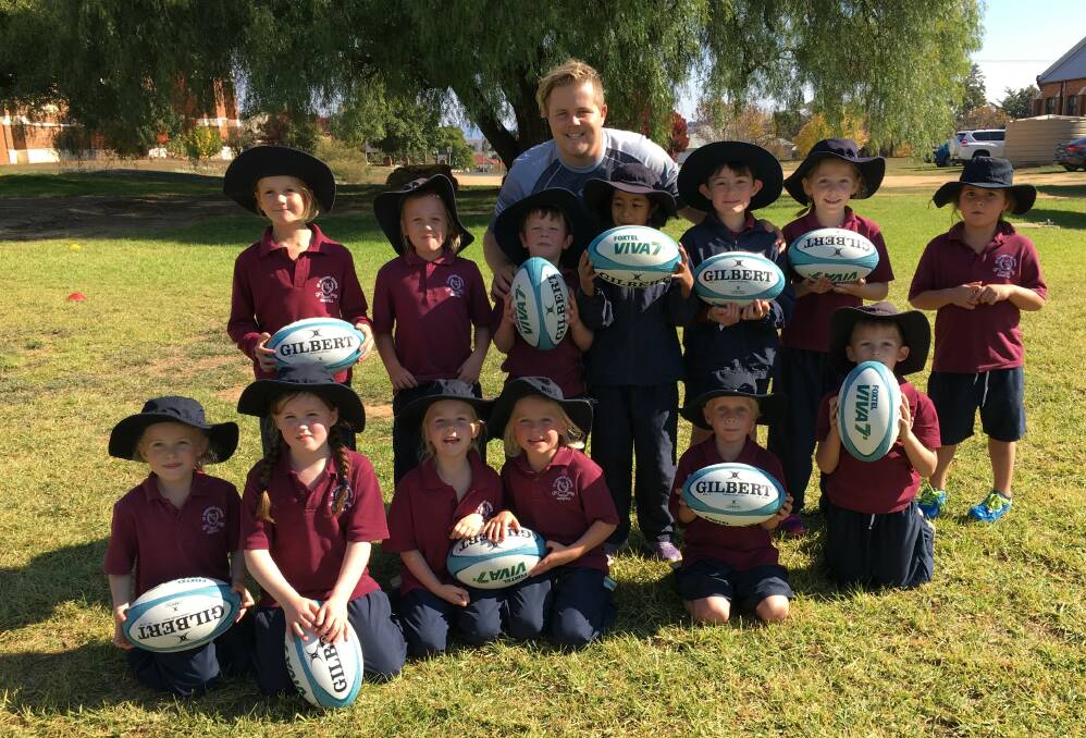 K/1 children and Seth at the end of their touch footy lesson with Seth Stoltenberg from the Brumbies.