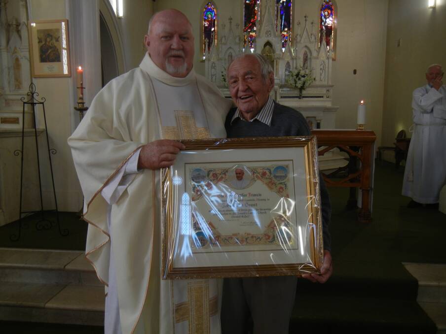Fr Tom Thornton presenting Jack Grant with his Papal Blessing during Mass.
