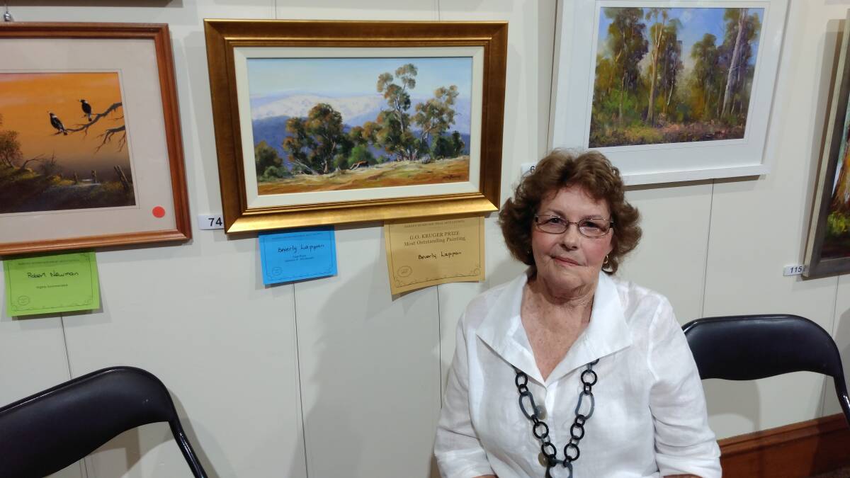 Bev Lappan' and her prizewinning painting "Grazing Cattle, Hill End". Contributed. 