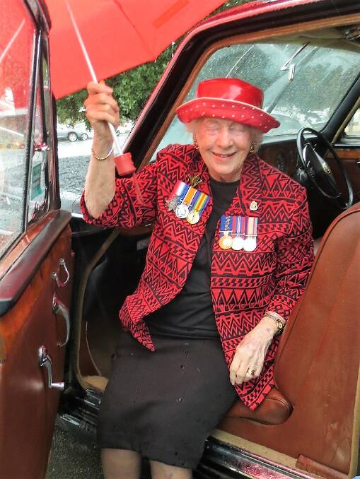 Kath Smith is all smiles on a wet Anzac Day as she exits the Daimler Limousine. (Contributed by J Hodgson)