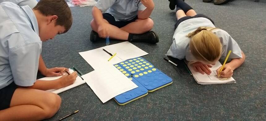 Yr 4/5 students solving maths problems.

 