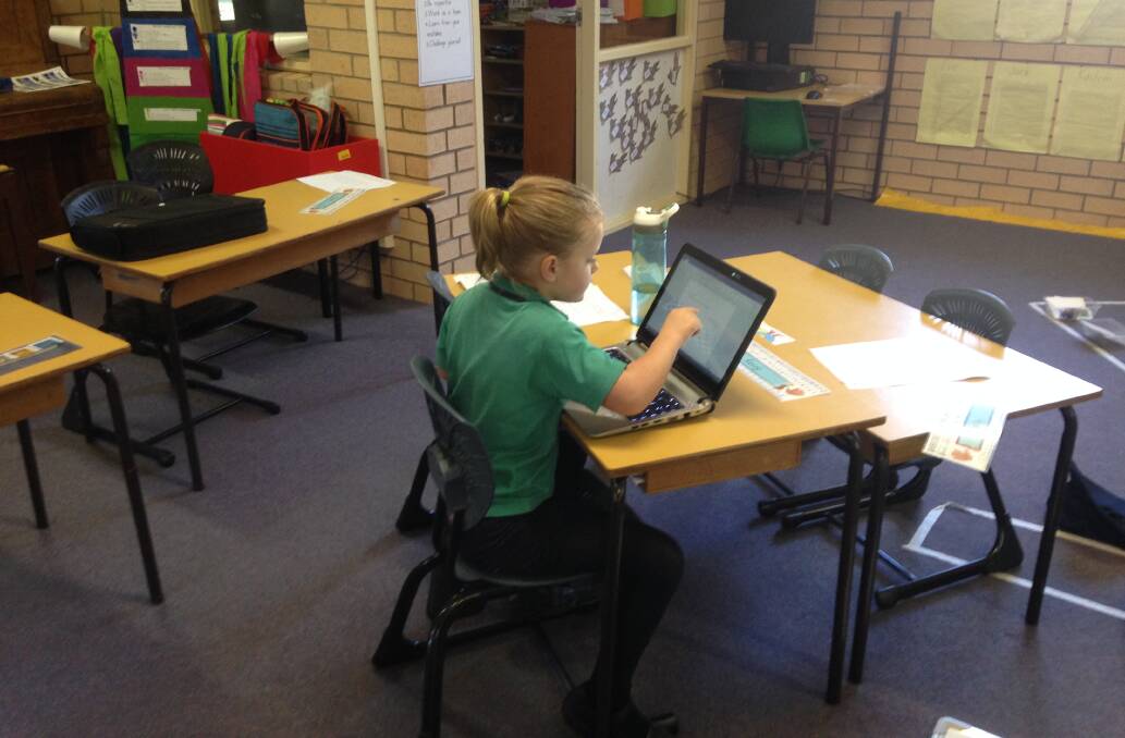 Students are learning to use technology such as iPads and computers for their studies.