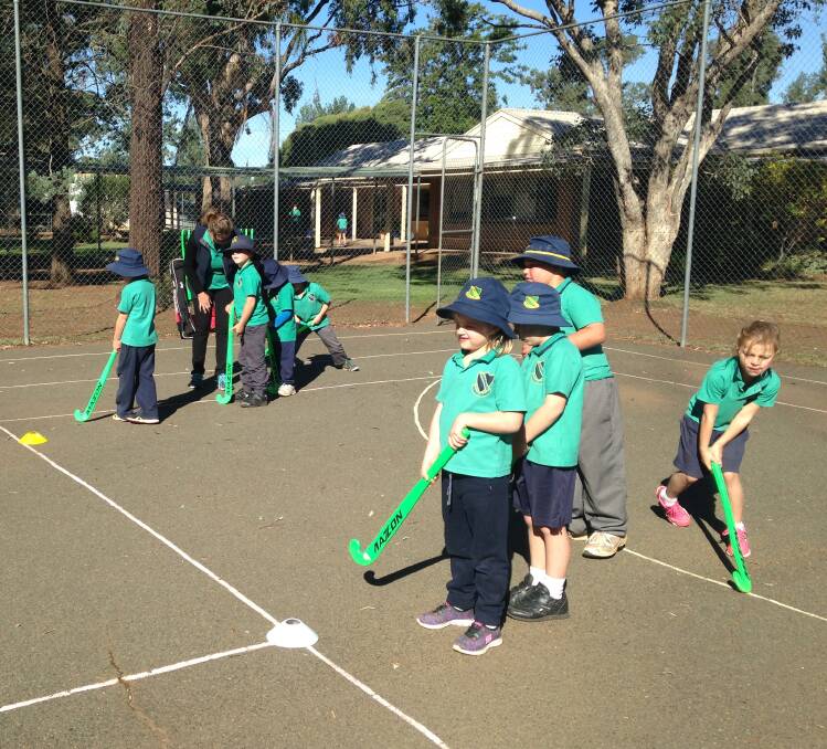 Geoff from Gecko Sports teaching the students some tips about various sports including hockey.