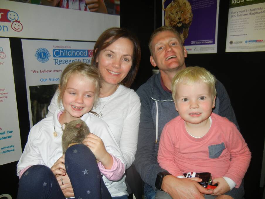 Jen and Tony Bell with their daughter Ava and son Charlie at the Childhood Cancer booth at the Hobart Lions Convention.