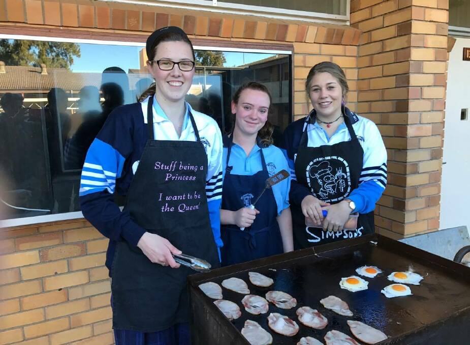 THLHS students Kate Robinson, Claira McAway and Caitlin Dixon cooking up a storm raising funds for motor neuron disease. Photo THLHS.