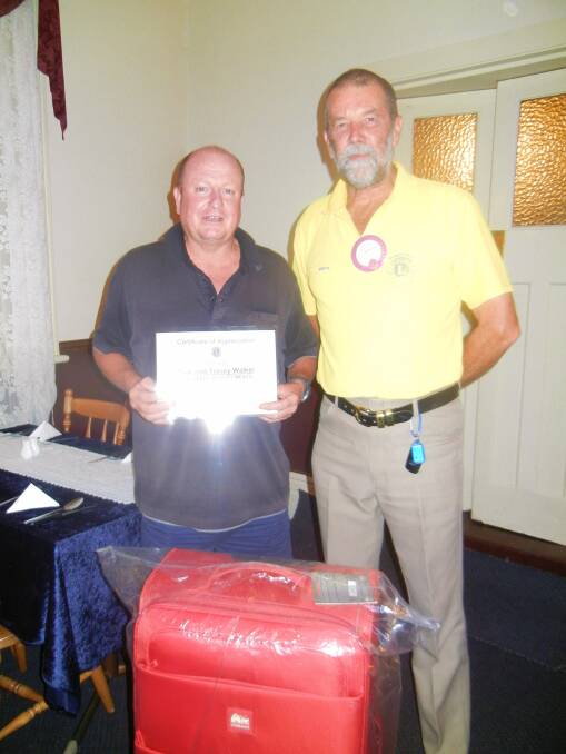 Lyle Walker being presented with a luggage package and Certificate of Appreciation from president of the Grenfell Lions Club Keith Engelsman.

