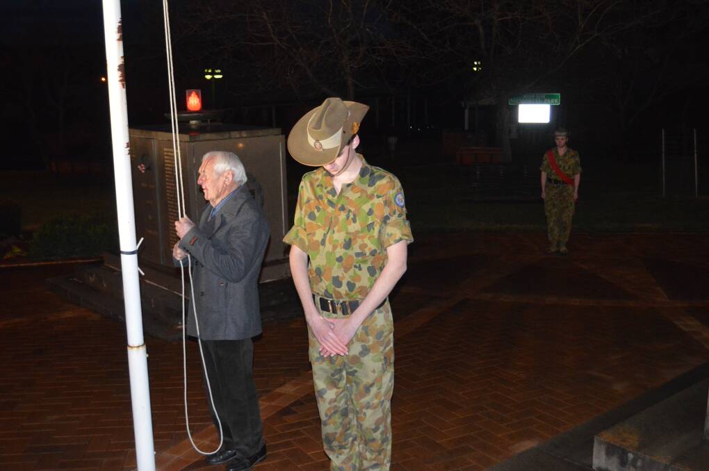 The flags are lowered to half mast at the RSL club's Long Tan Day ceremony last Friday evening.