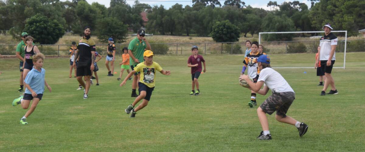 Grenfell Junior Rugby League players train with professionals from NRL during a junior coaching clinic held in Grenfell last month.


