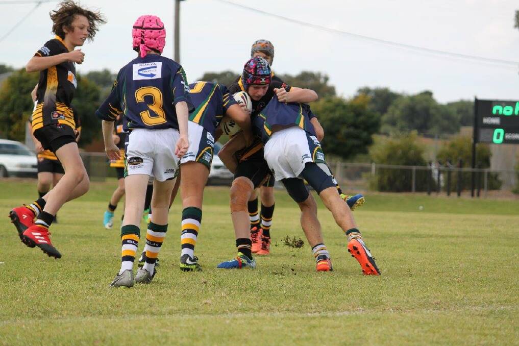 U14's player Dylan King smashes through the opposition in a recent match at Lawson Oval. Photo Facebook.