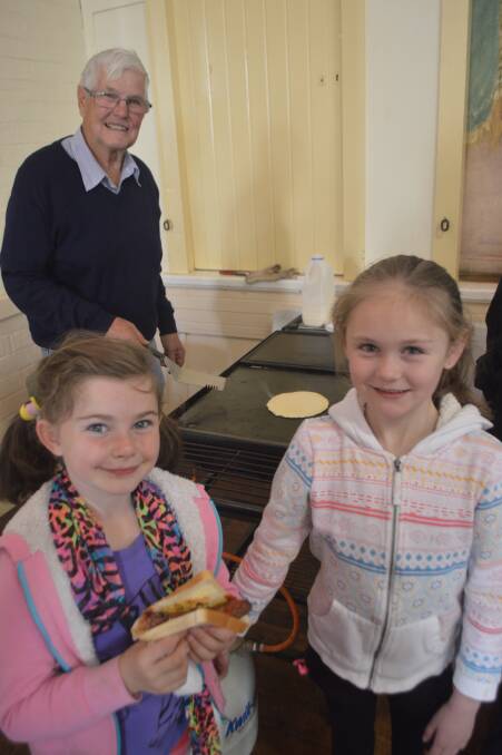 Colin Wood serves up his delicious pancakes with April O'Conner and Allana O'Grady at the Anglican fete.