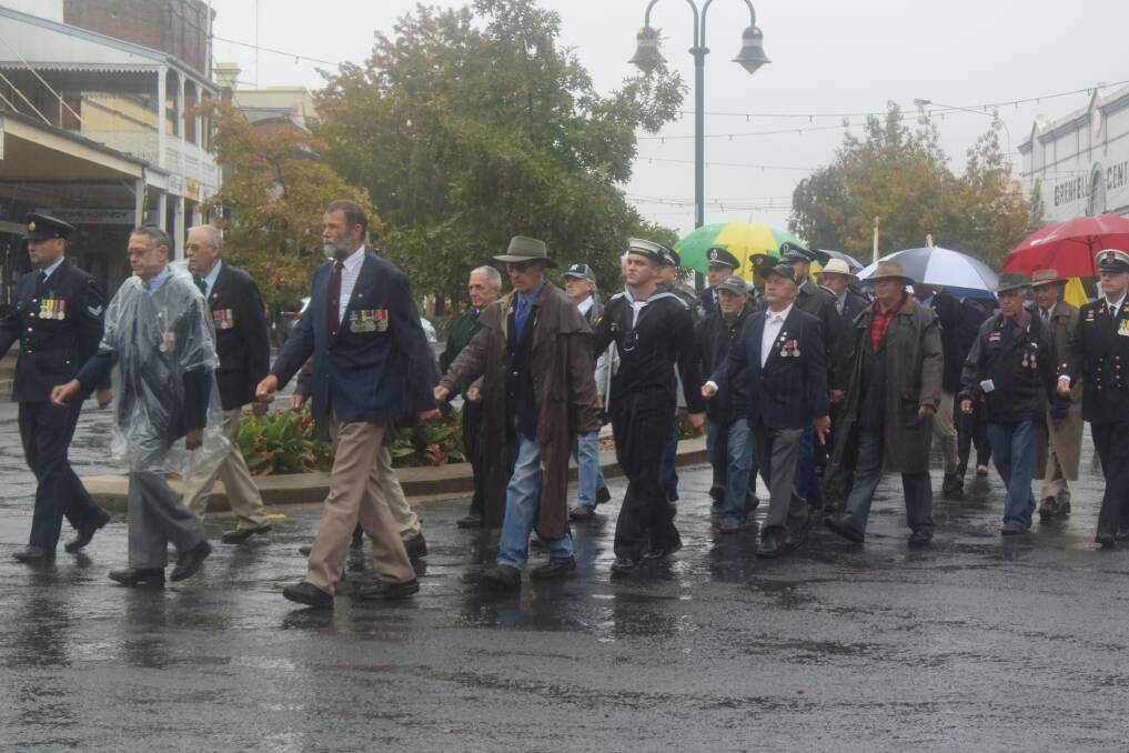 Members of the Grenfell RSL along with local emergency service personnel, schools, cadets, scouts, girl guides and other organisations and individuals marched up Main Street despite the heavy downpour.