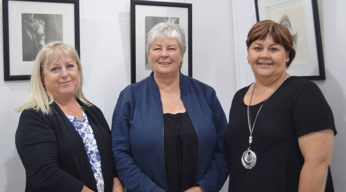 Admiring Ann Gilbert's artwork are friends Julie Butler (Yallah) with Ann and Carolyn Kohler (Mt Tyson QLD) last Saturday at the Grenfell Art Gallery. 
