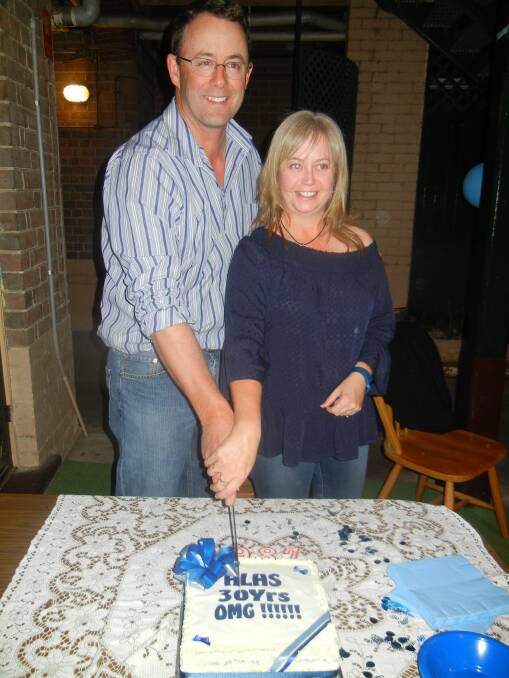 James Ingey and Joyce Minette cutting the 30th anniversary reunion cake.  