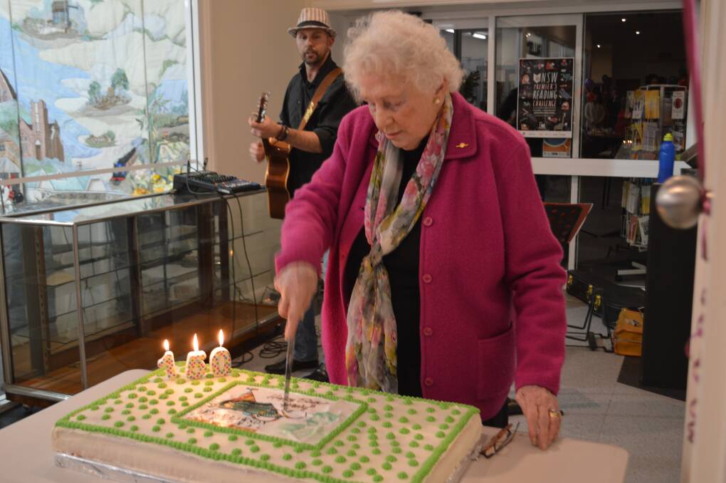 Grenfell's Kathleen Smith cuts Henry's mammoth 150th birthday cake.