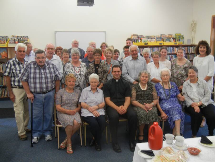 Father Paul Nulley with parishioners  of St Joseph's at his farewell morning tea.


