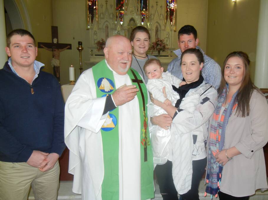 Lettie Jane Hunter with her parents, godparents and Fr Tom Thornton. 