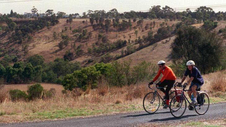 Ride: 980204: Pic Simon O'Dwyer : Metro: Pic Shows: Keith Dunstan and friend look over the view as they ride through  Brimbank Park in Keilor East. PART OF THE BIKE RIDE SERIES , bike riders Photo: Simon O'Dwyer