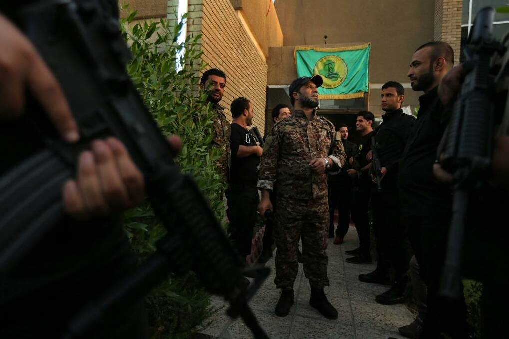 Don't call them militias: Haji Jaafar al-Bindawi (centre) with his men at the Imam Ali Brigade's headquarters in Baghdad. Photo: Kate Geraghty