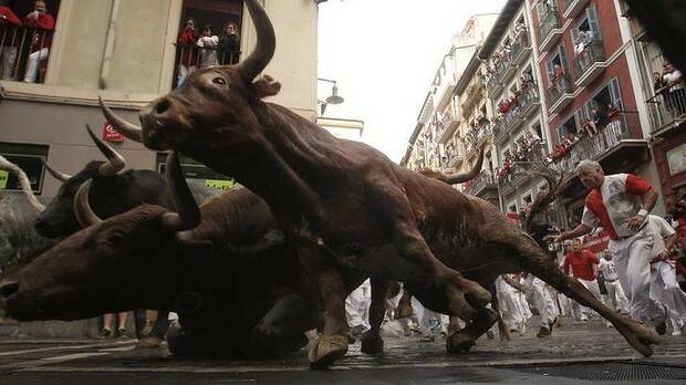 ON THE RUN: Revellers from around the world come to Pamplona every year to take part in some of the eight days of the running of the bulls. Photo: AP