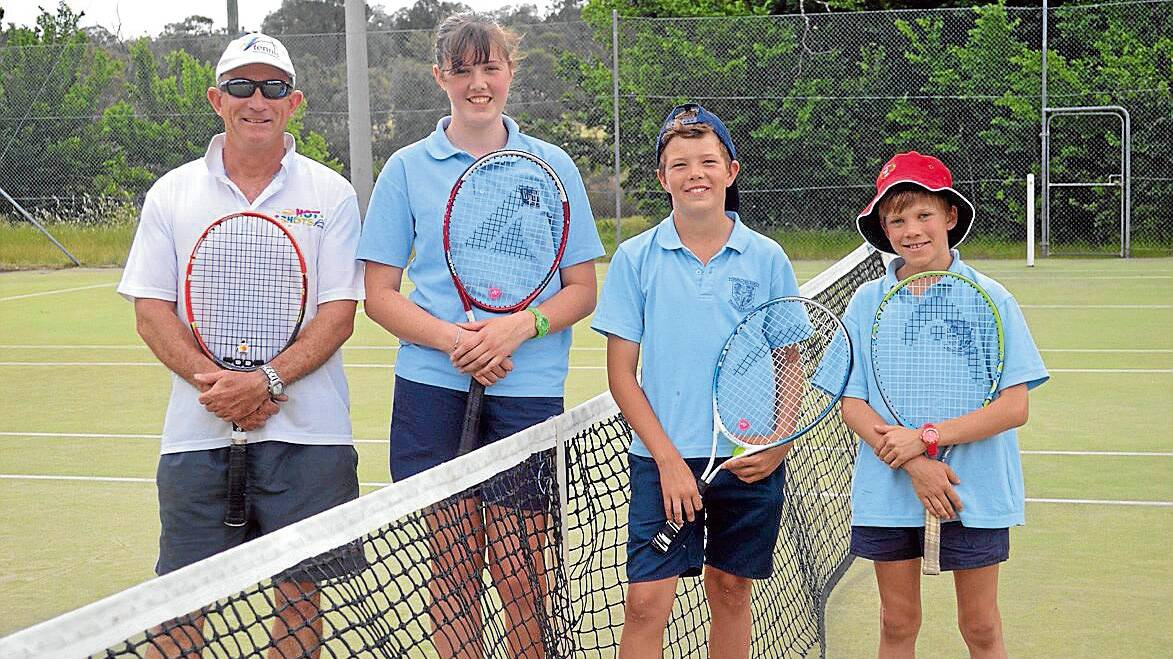 Tennis Coach Peter Clifton with students Kate and Tom Robinson and Hugo Fenton during last Fridays training at the Grenfell Tennis Courts.