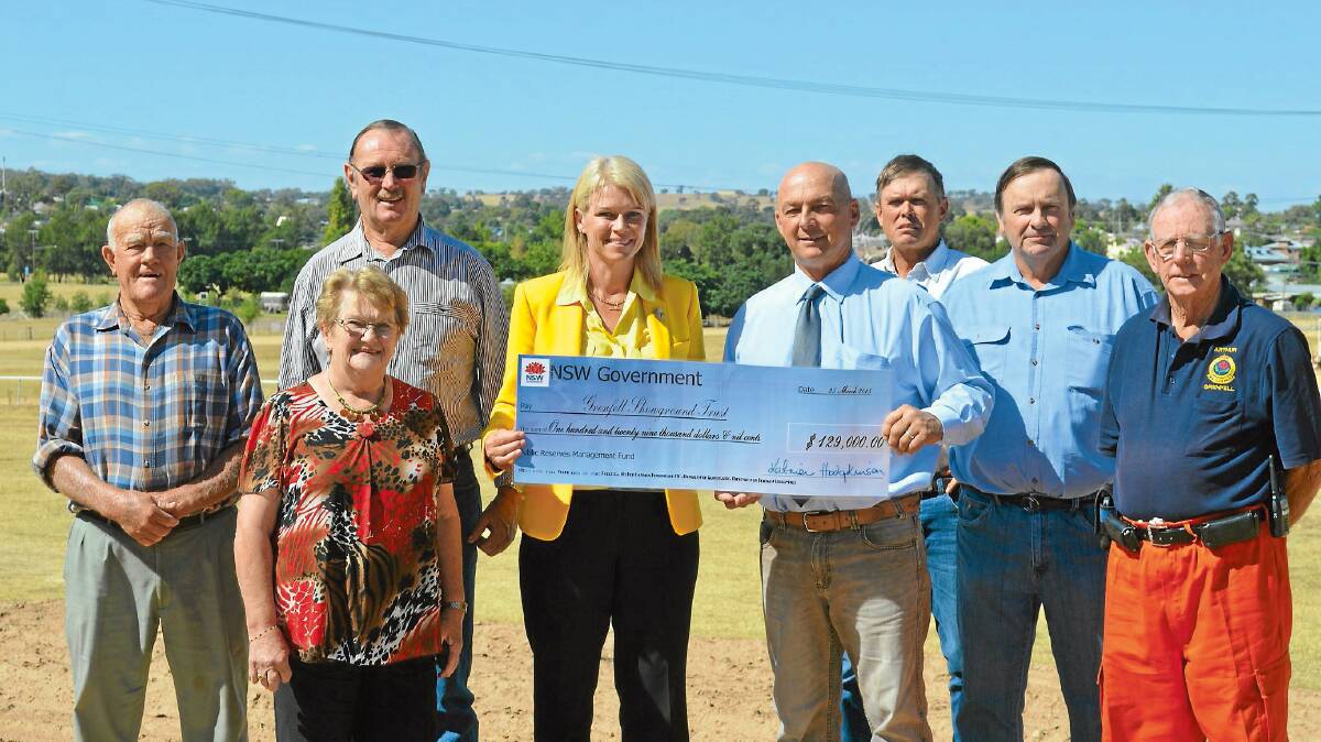 Katrina Hodgkinson MP at the Grenfell Showground on Wednesday presenting the committee representatives with the huge cheque. Pictured here with Katrina are Nev Condon (Show Society), Don Forsyth (Muster Committee and Showground Trust), Joan Eppelstun (Show Society), Mark Liebich (Show Society), Murray Mitton (Showground Trust), Philip Walmsley (Showground Trust) and Arthur Richardson (Show Society).