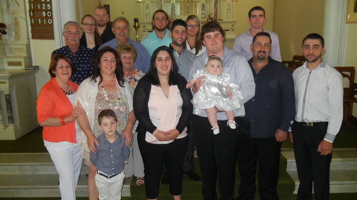The extended family of Leila Lee Ainsworth pictured in front of the altar at St Joseph’s Catholic Church following her baptism on Sunday morning.