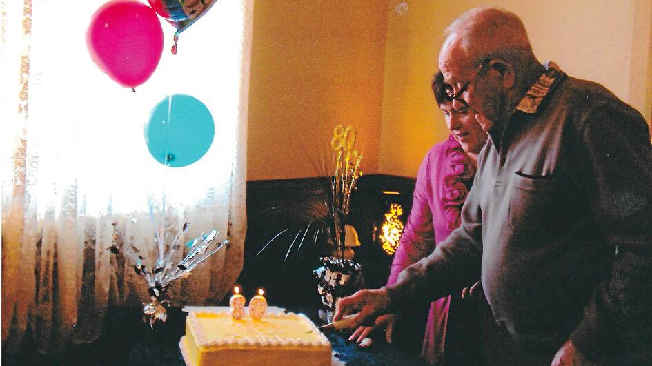 Jack Gee cutting his 80th birthday cake at a family, friends and neighbours celebration at Fettlers Restaurant. Jack's daughter Kathy Day is assisting her dad. (Photo contributed)