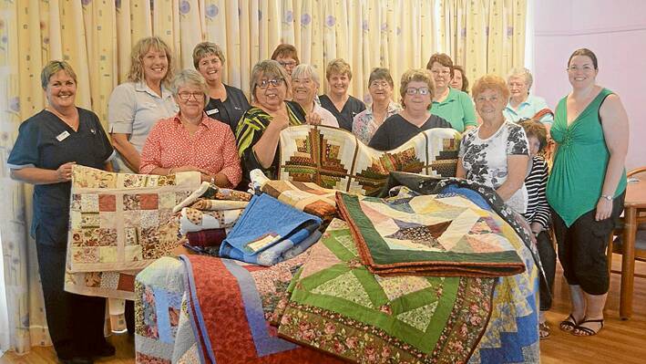 Pictured here are the creators of the quilts along with MPS Staff members during the distribution last Thursday: Reet Wheeldon, Eve Balcomb, Julie Hughes, Rosalie White, Barbara O’Meally, Gemma Ryan, Erica Moore, Norma Walker, Debbie Stevens, Naomi Steinhardt, Gloria Wilder with MPS Staff Nicole Widdows, Francine Pirie, Di Halloran, Chris Hawkes and Julie Wood. Absent from the photo but also involved in creating the quilts were Gwenda Hazell, Chris Simpson, Marion Knapp and Edna Meridith.  