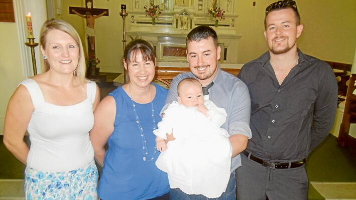 Rhys Owen Thomas held by his father Rory is pictured with his mother Stacey, godmother Emma Duval (L) and godfather James Maxworthy following his baptism on Sunday morning in St Joseph’s Church. 