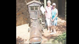 GARDEN RAMBLE: Checking one of Len’s fabulous and creative mechanical sculptures “The old Woman who Lived in a Shoe’ were Valerie Knight and her granddaughter Elaine who was visiting her from Canberra.
