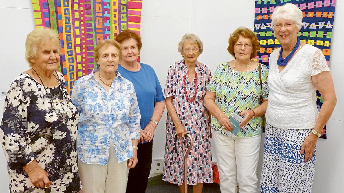 These ladies from the Grenfell Art Group had their Christmas Party before visiting the Gallery to see the Living Colour Collection.
They were delighted with the use of bright colour in the collection.
Pictured in front of the exhibition curator Brenda Gael Smith’s quilts are local artists (L-R) Neva Napier, Pam Pearce, Judy Mitton (gallery volunteer), Merle Hughes, Bev Lappan and Pat Brus. (Photo Contributed)
 