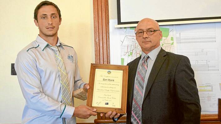 Sam Myers receiving his certificate and gift from Weddin Shire Council Mayor, Mr Mark Liebich, at his Civic Reception held in the Council Chambers on Thursday, October 16, 2014. 
