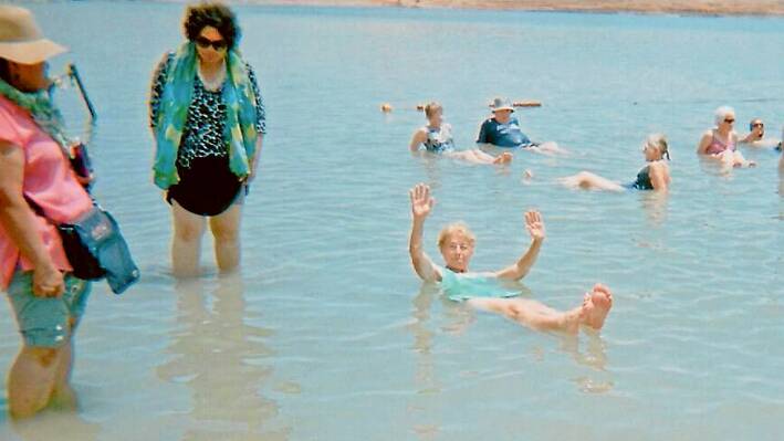 Grenfell Librarian Anne Gault  (waving) enjoying  a dip in the Dead Sea. 