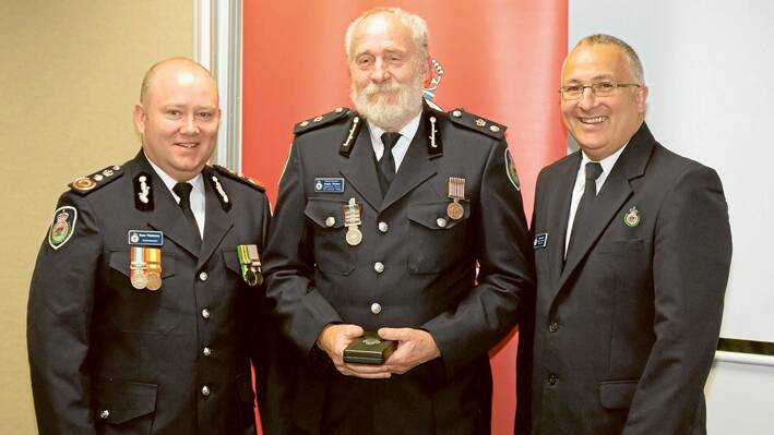 (C) Grenfell’s Angus Nielson, Superintendant/Operating Officer for Mid Lachlan Valley Rural Fire Service receiving his Long Service Award (LSA) for 40 years of service with the Rural Fire Service from (R) Rural Fire Service Commissioner Shane Fitzsimmons and Region West Manager Paul Smith.  