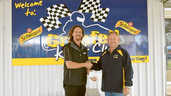 Schweppes, the famous international soft drink company, has come on board as major sponsor for the NSW State Championships to be held this October Long Weekend at Grenfell. Their local representative Gavin Johnson (l) of Grenfell, is seen here being congratulated by Grenfell Kart Club President Craig Sargent at last weekend's Kart Club race day at the Bogolong Circuit. 