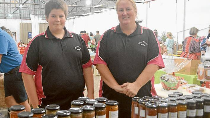 Mother and Son Paula & Bryce Warnke serving at their "In a Pickle" condiments, jams, chutneys and more stand during the Breakfast Table Twilight Markets at the Grenfell Showground last Saturday November 15. 