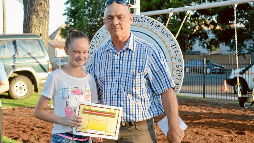 Winner of the Grenfell Christmas Lights Competition for 2013 was the Hooper  Family, accepting the award from Weddin Shire Mayor Mr Mark Liebich was Kayli Meier at the 2013 Combined Service Clubs' Christmas carnival. 