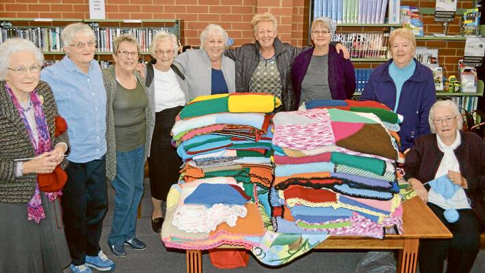 Standing around the fruits of their labors for this “Knit, Natter & Nibble” season at the Grenfell Library on Wednesday morning were all of our proud knitters and ABC’s Brooke Daniels. They are (l/r) Lola Madden, Jenny Wells, Astrid Bevins, Dot Lamkin, Helen Masman, Brooke Daniels, Elaine Blomdale, Ruth Gardner and Nancy Jones.   