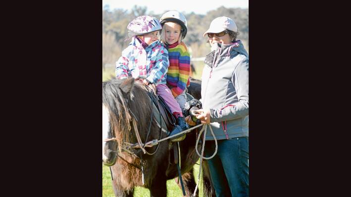 Some young fans at the Polocrosse which made a welcome return to the Grenfell Racecourse in July. 
