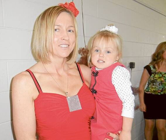 Summah Scott one of the youngest at the Grenfell Branch Red Cross Australia Melbourne Cup Luncheon at the Grenfell Country Club with her mother Tina.