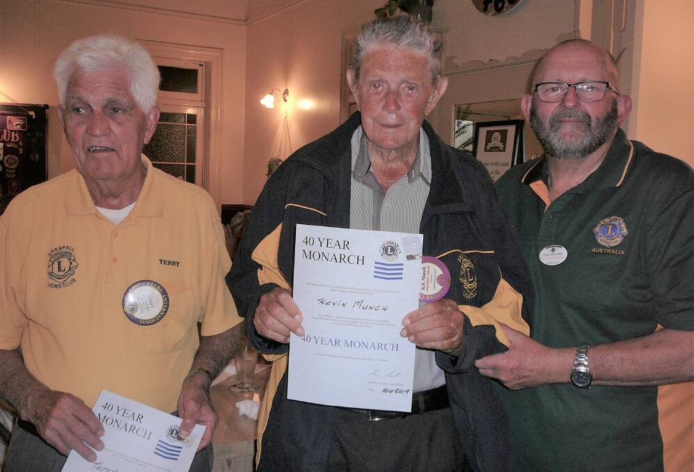Second VDG Lion Ron Parry presenting Monarch Pins to Lions Terry Carroll (41) and Kevin Munck (40).