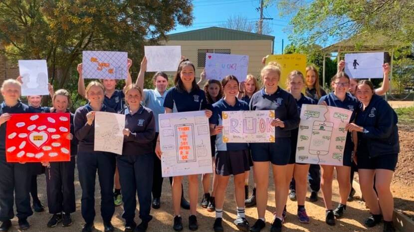 Students from The Henry Lawson High School displaying their R U OK? Day posters. Photo: THLHS.