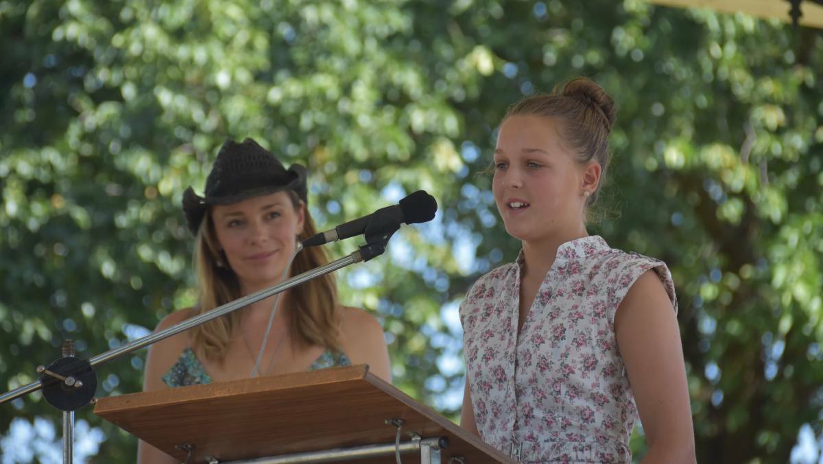 2019 Australia Day ambassador Zoe Naylor watches on as Annabella Taylor says a speech after receiving her academic award.