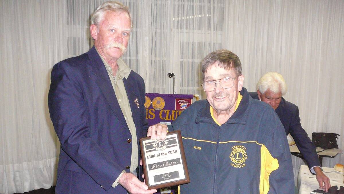 AWARD: Lion Peter Butcher receiving the Lion of the Year Award from PP Chris Moran.